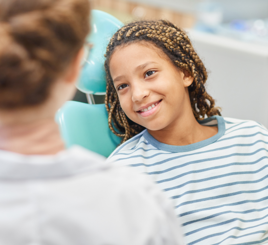 young girl in dental chair ready for her early orthodontic exam by a pediatric orthodontist