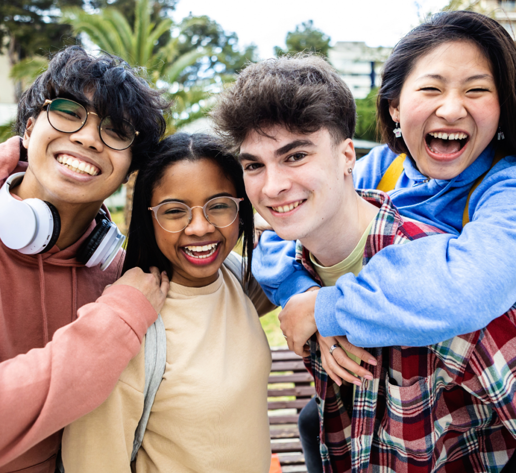 group of smiling friends in need of orthodontics for teens