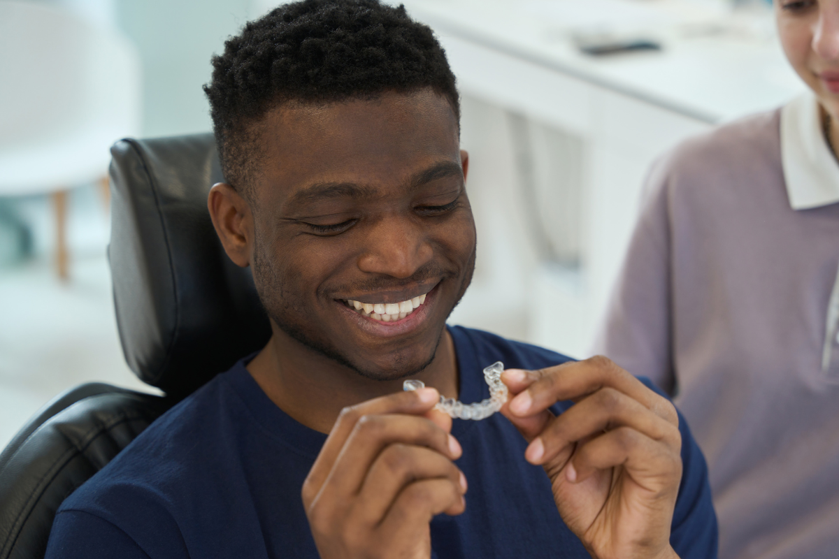 adult male inserting his invisalign tray
