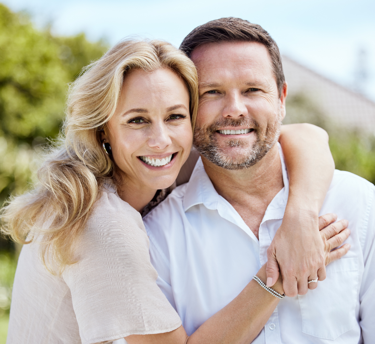 smiling mature couple showing off straight teeth after adult braces