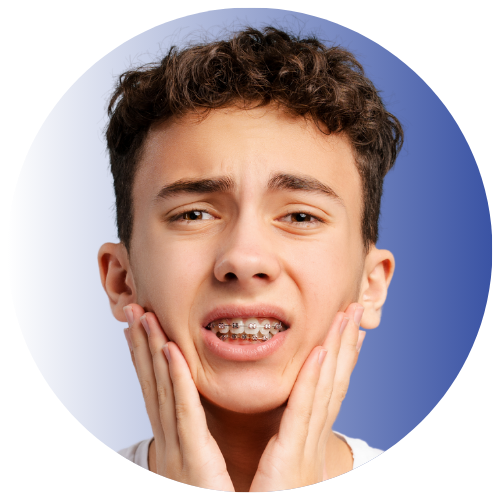boy with sore teeth from braces