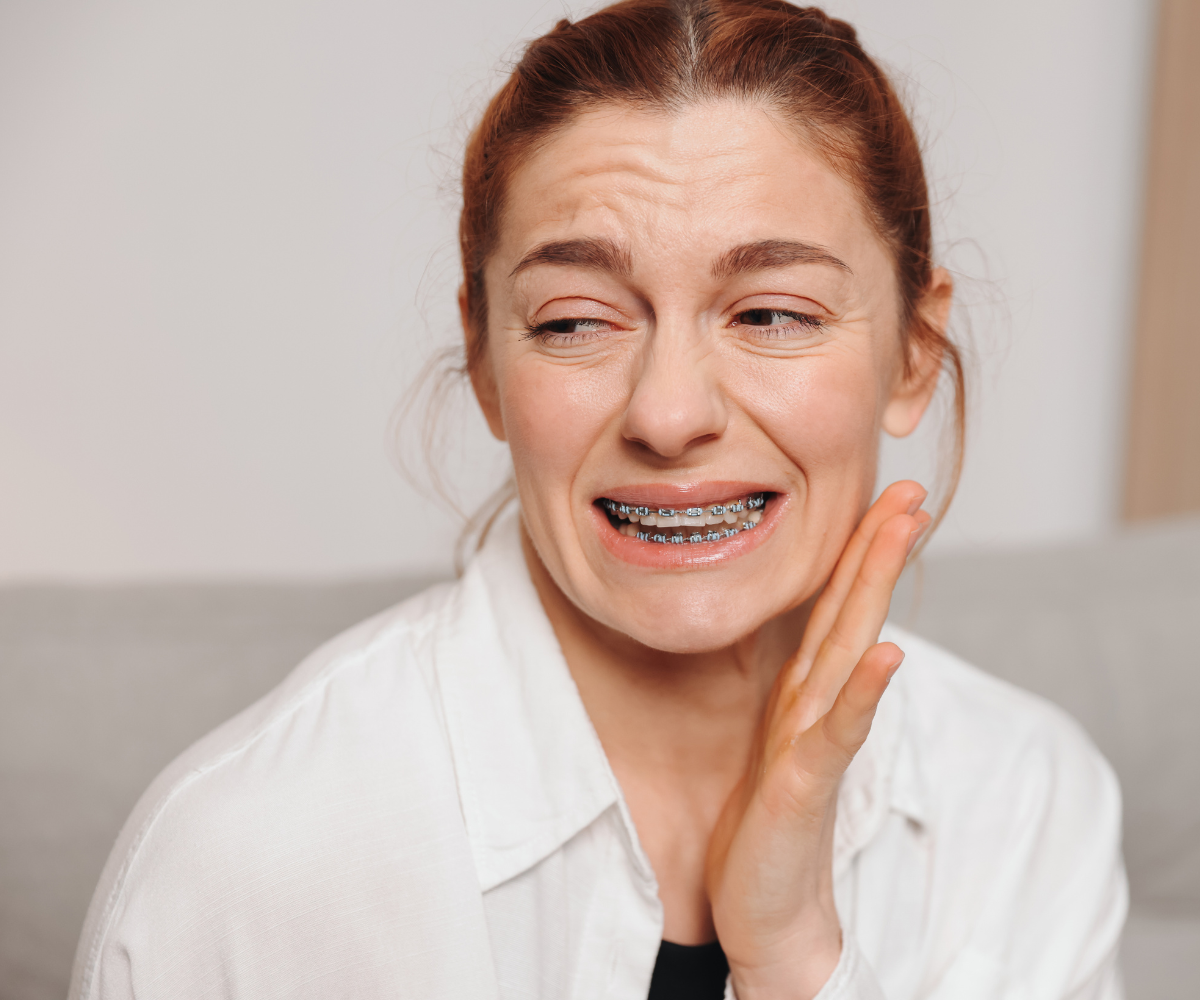 woman experiencing pain wondering if she's in need of an emergency orthodontist