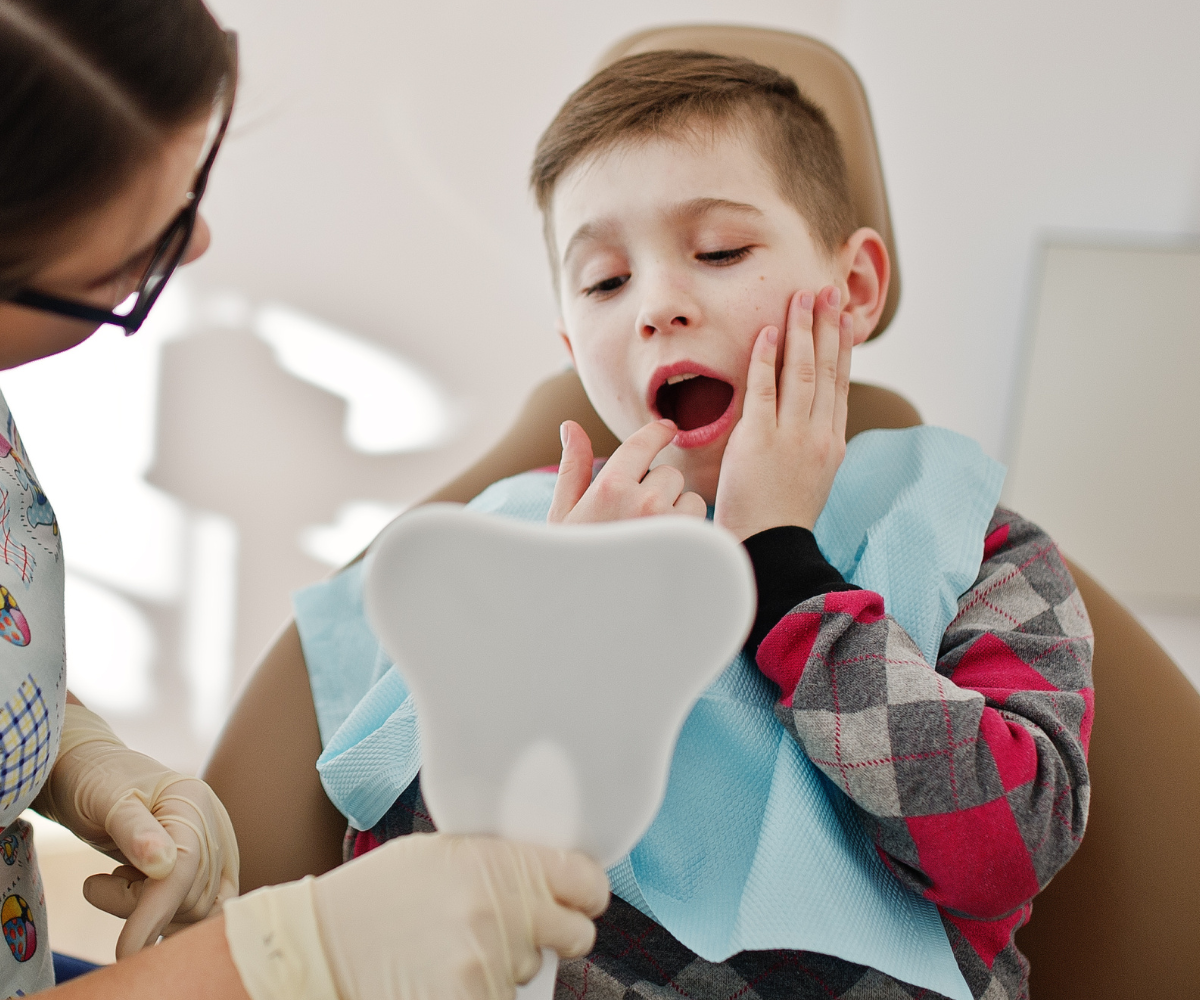 boy experiencing jaw pain from clenching and tmj disorder