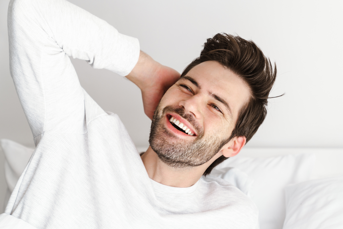 man waking up feeling refreshed after treatment for his sleep and airway problems from his orthodontist