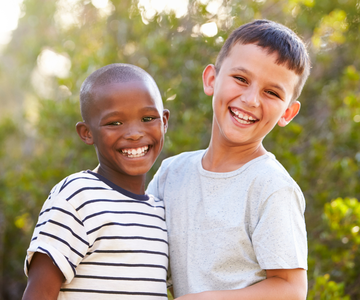 smiling 7 year old boys at the right age for their first orthodontic evaluation