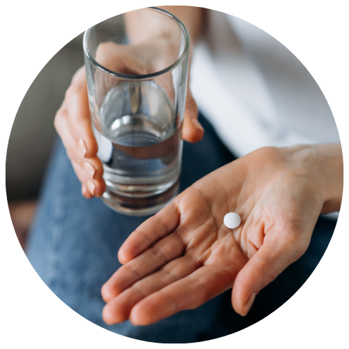 woman taking pain reliever with water to ease orthodontic discomfort