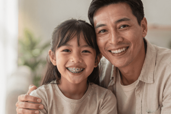 child with braces after dad found out they were very affordable