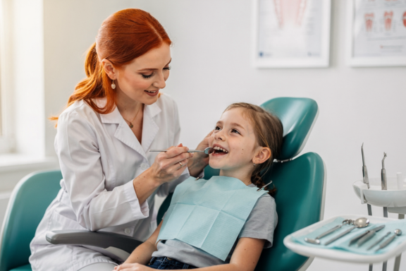 orthodontist looking at child's teeth to see what is needed